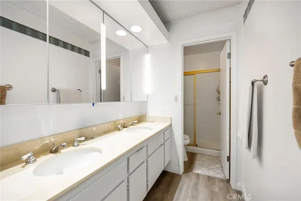 a bathroom with a sink a toilet and shower