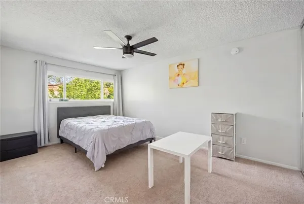 a bedroom with a bed and a window