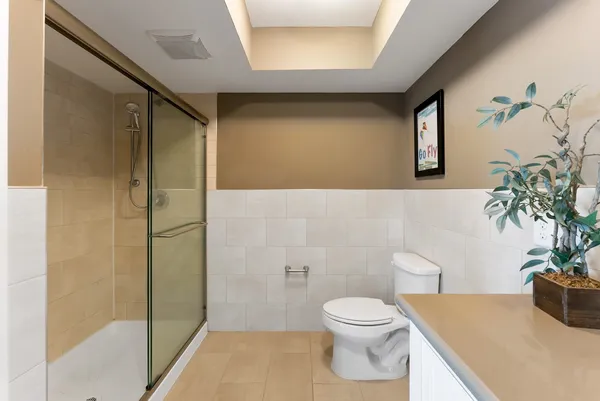 a bathroom with a sink a toilet and shower