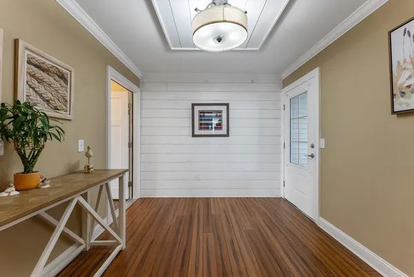 a view of a room with wooden floor and potted plant