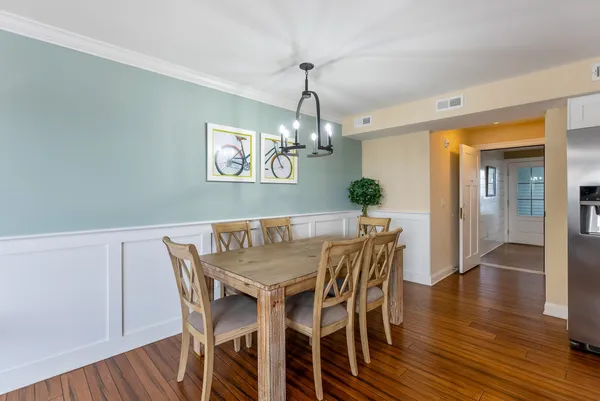 a view of a dining room with furniture wooden floor and chandelier