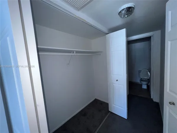 a bathroom with a sink vanity granite and toilet