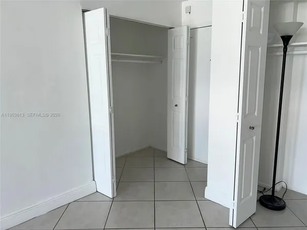 a bathroom with a granite countertop toilet sink and mirror