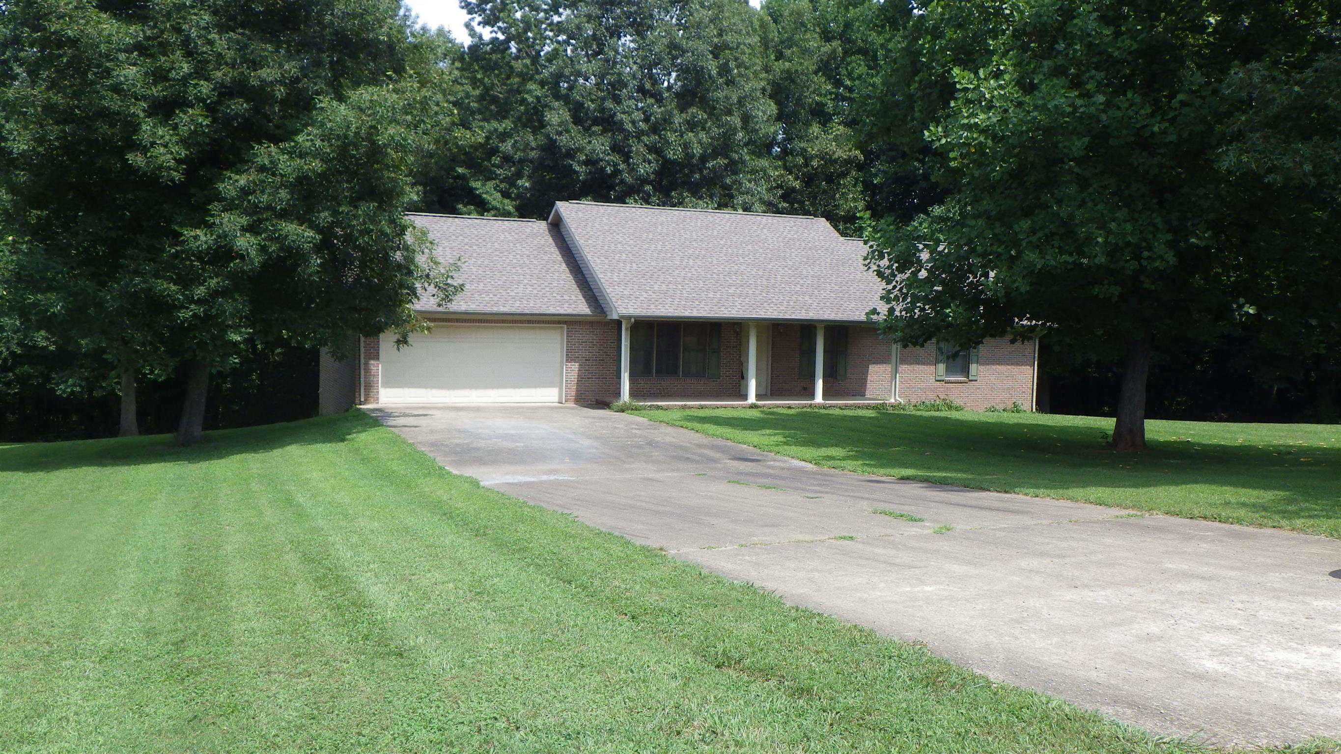 6502 North Pinson Road Portland, TN 37148 - Photo 2 of 22 a front view of a house with a yard and trees