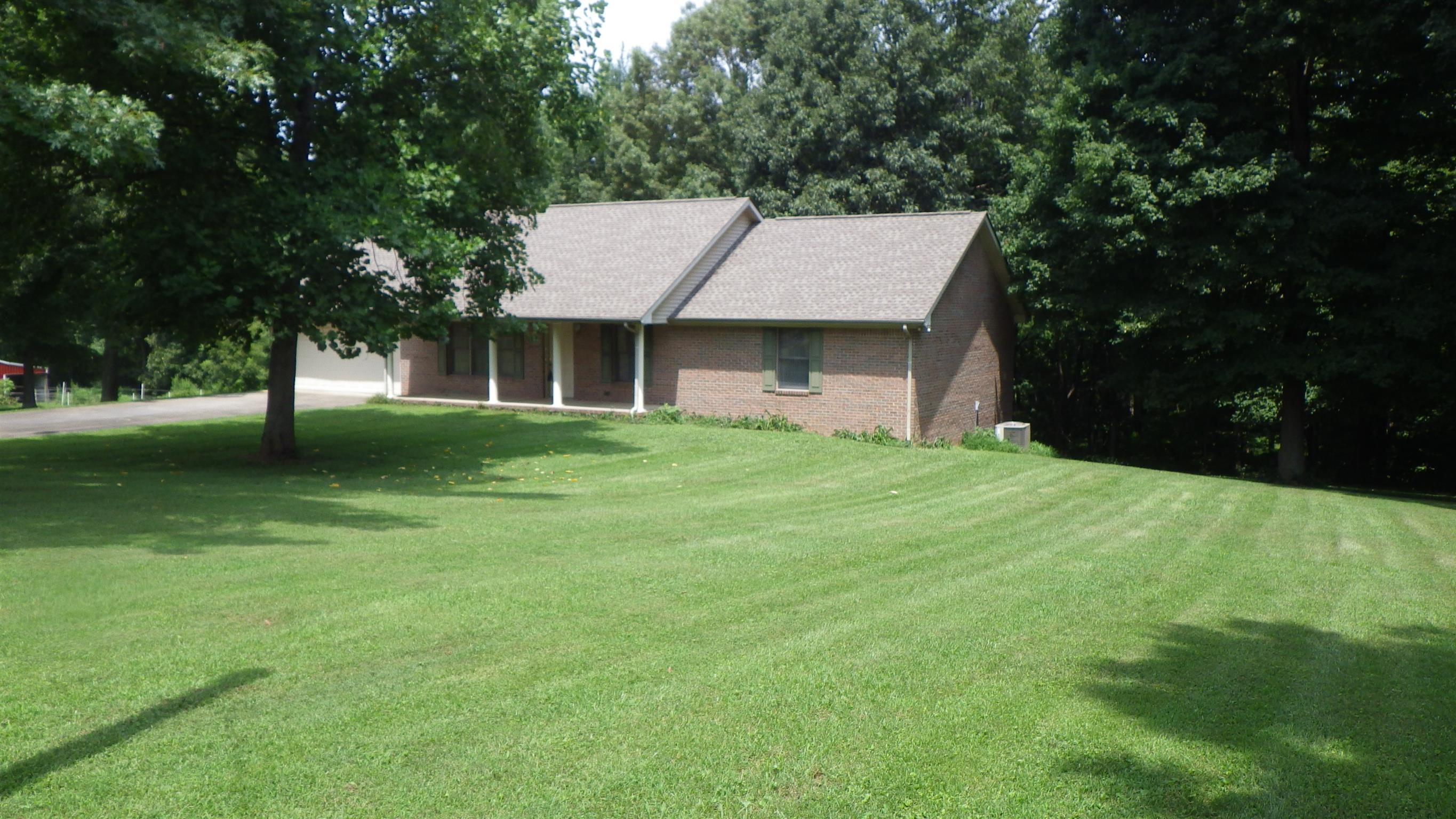 6502 North Pinson Road Portland, TN 37148 - Photo 3 of 22 a front view of a house with a garden