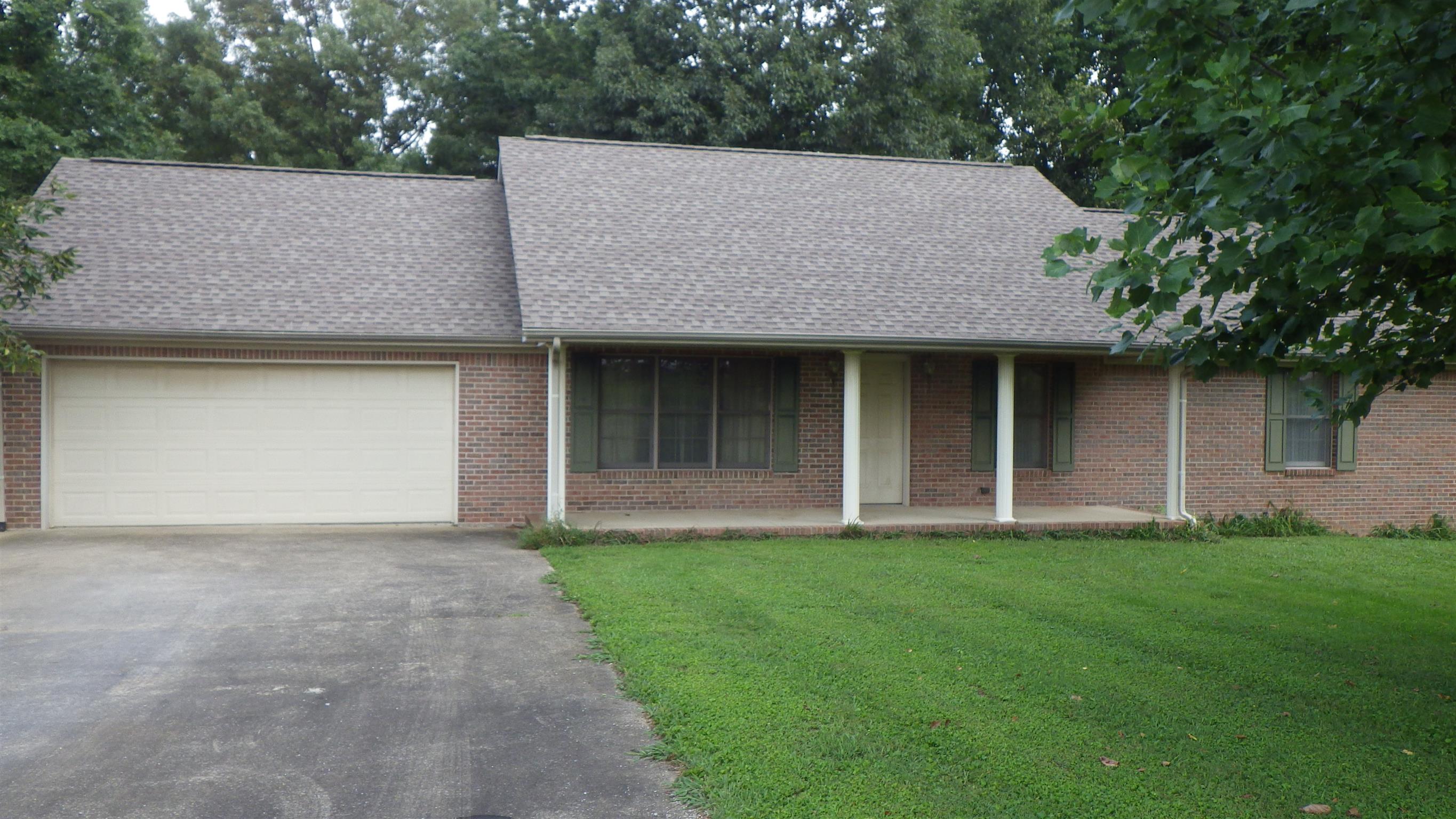 6502 North Pinson Road Portland, TN 37148 - Photo 5 of 22 a front view of a house with a garden and trees
