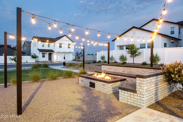 a view of a house with swimming pool and sitting area
