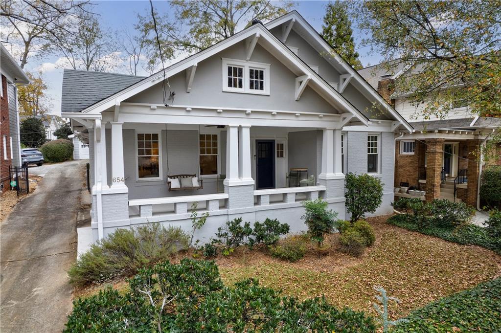 a front view of a house with a yard and porch