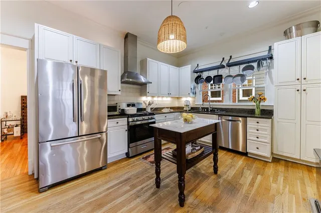 a kitchen with stainless steel appliances granite countertop a stove and a sink
