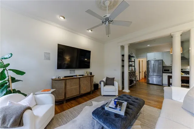 a living room with furniture and a flat screen tv