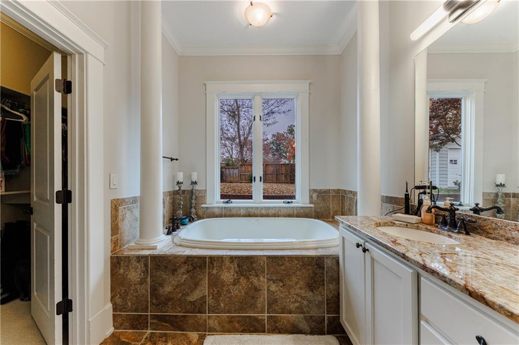 654 Cresthill Avenue Northeast Atlanta, GA 30306 - Photo 35 of 53 a bath tub sitting next to a bathroom sink