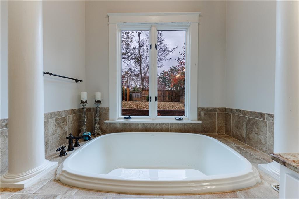 654 Cresthill Avenue Northeast Atlanta, GA 30306 - Photo 36 of 53 a bath tub sitting in a bathroom next to a window