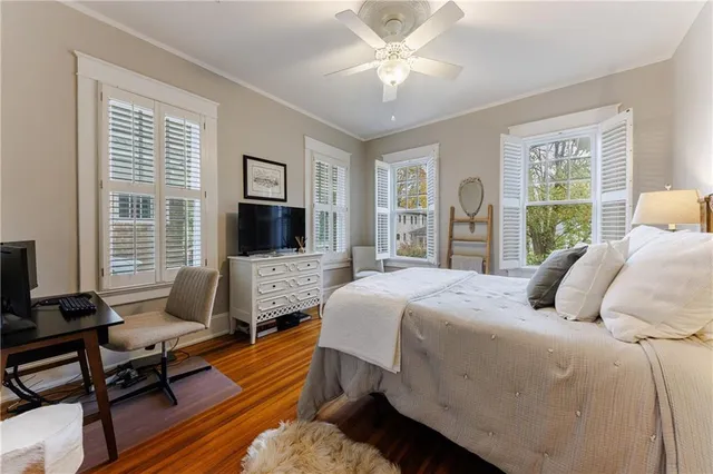 a bedroom with a bed and wooden floor