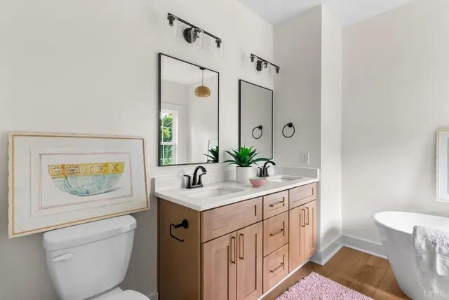 a bathroom with a toilet a sink and mirror