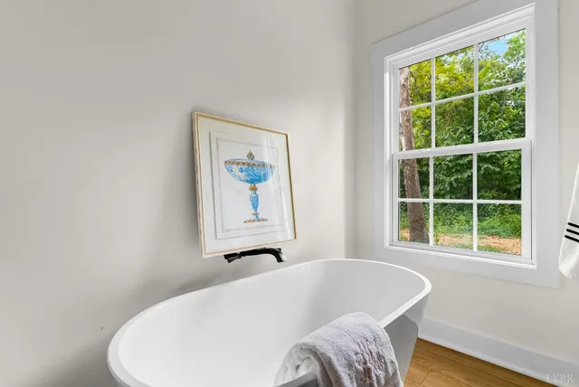 a bathroom with a bathtub and a window