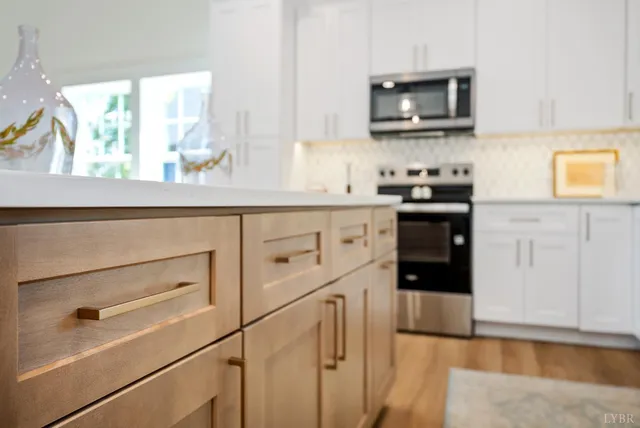 a kitchen with stainless steel appliances granite countertop a stove and a microwave