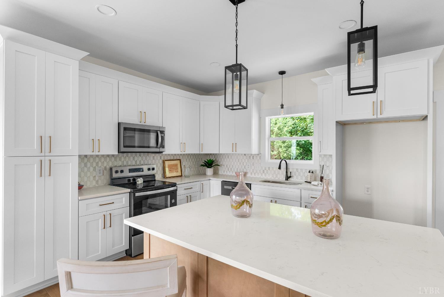 10 Madison Avenue Danville, VA 24540 - Photo 9 of 44 a kitchen with stainless steel appliances kitchen island granite countertop a sink a stove and a refrigerator
