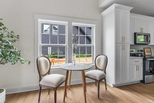a view of a dining room with furniture window and wooden floor
