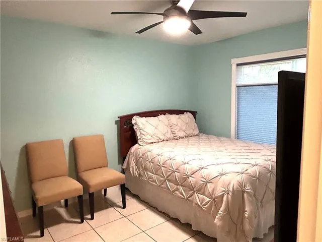 a bedroom with a bed and a chair