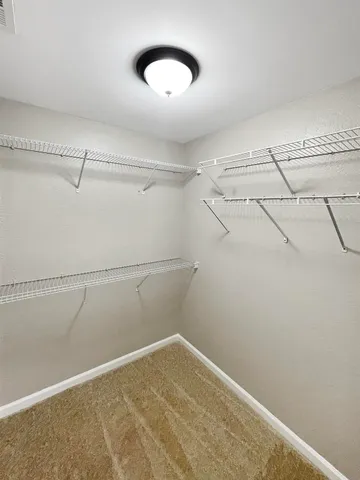 a spacious bathroom with a tub sink and mirror