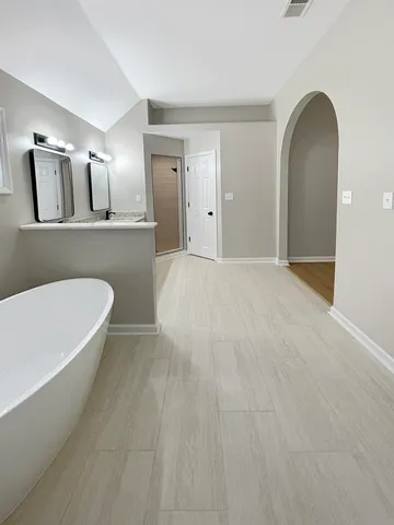 a bathroom with double vanity sinks and a mirror