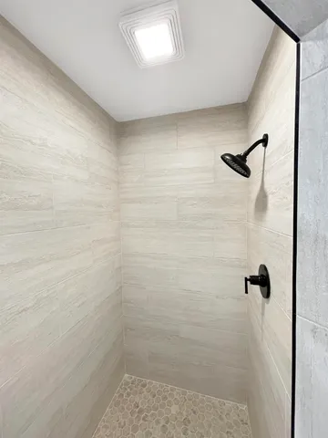 a view of an empty room with a fireplace and a window