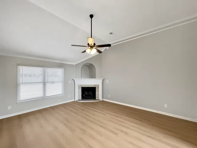 a kitchen with granite countertop a sink stainless steel appliances and white cabinets