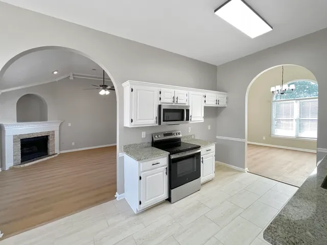 a kitchen with stainless steel appliances granite countertop a stove a sink and a granite countertops