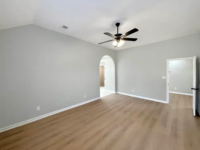 a view of a livingroom with a ceiling fan and window