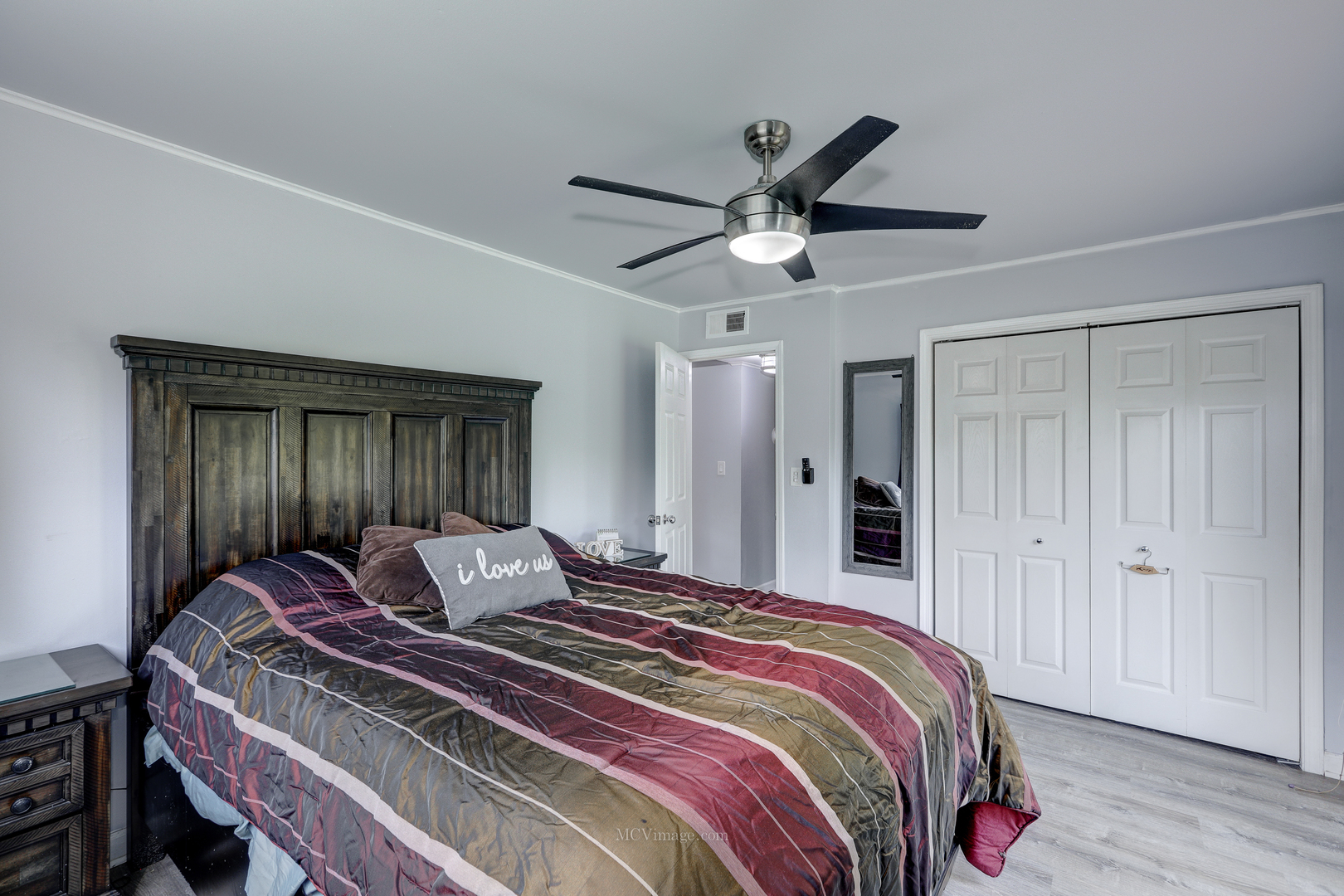 3 Manor Road Lake Zurich, IL 60047 - Photo 14 of 35 a bedroom with a bed and a chandelier