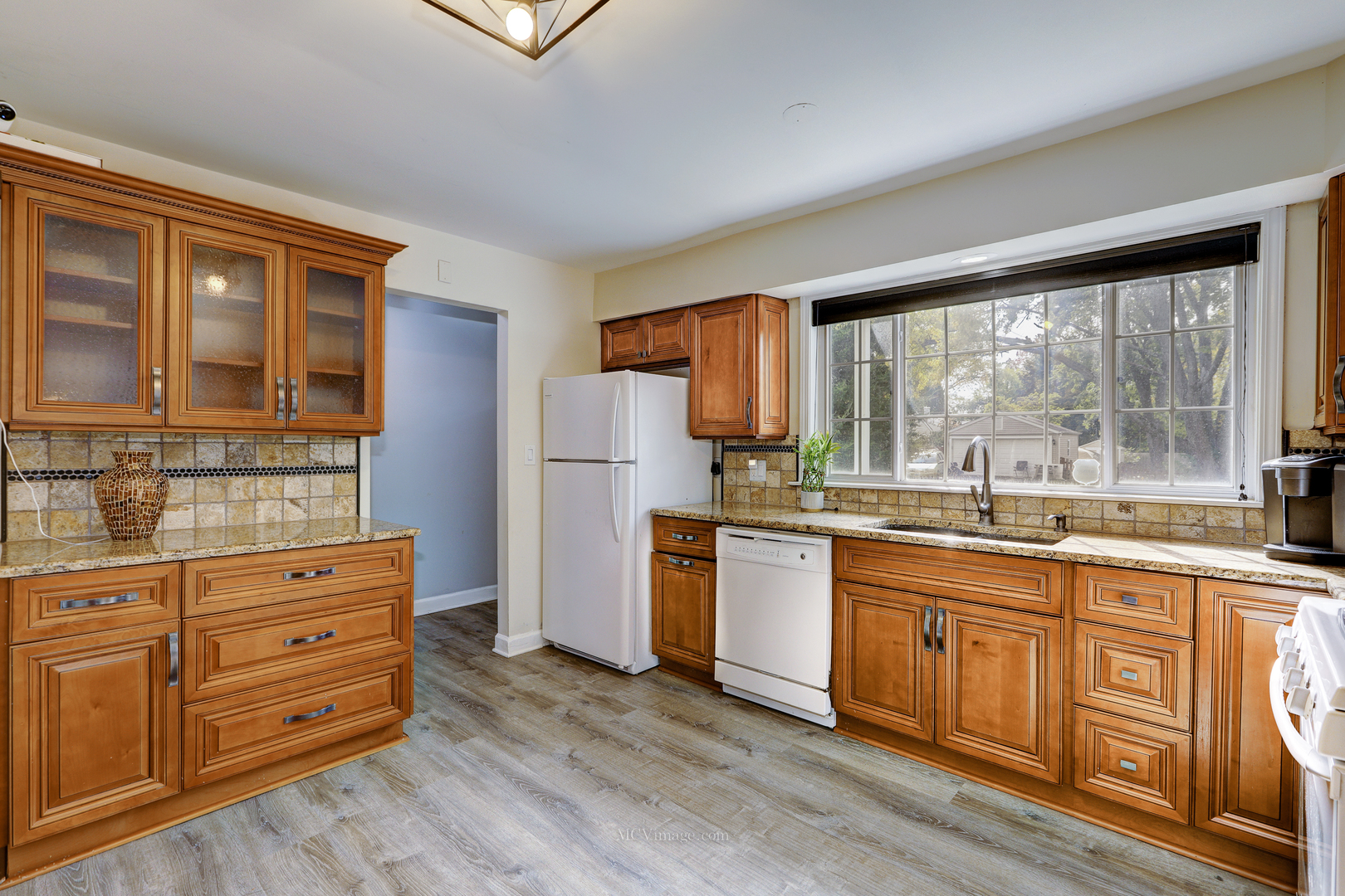 3 Manor Road Lake Zurich, IL 60047 - Photo 7 of 35 a kitchen with stainless steel appliances granite countertop a refrigerator sink and cabinets