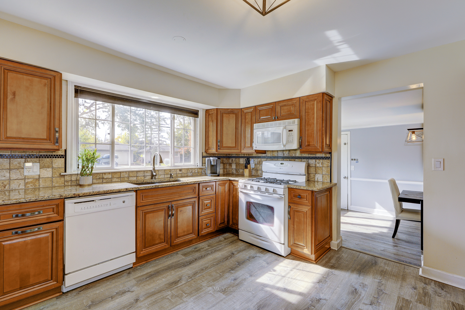 3 Manor Road Lake Zurich, IL 60047 - Photo 8 of 35 a kitchen with stainless steel appliances granite countertop a stove a sink and a microwave