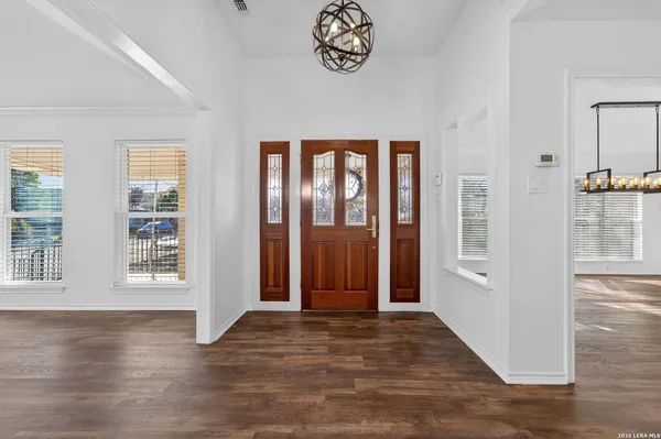 an empty space with wooden floor and windows