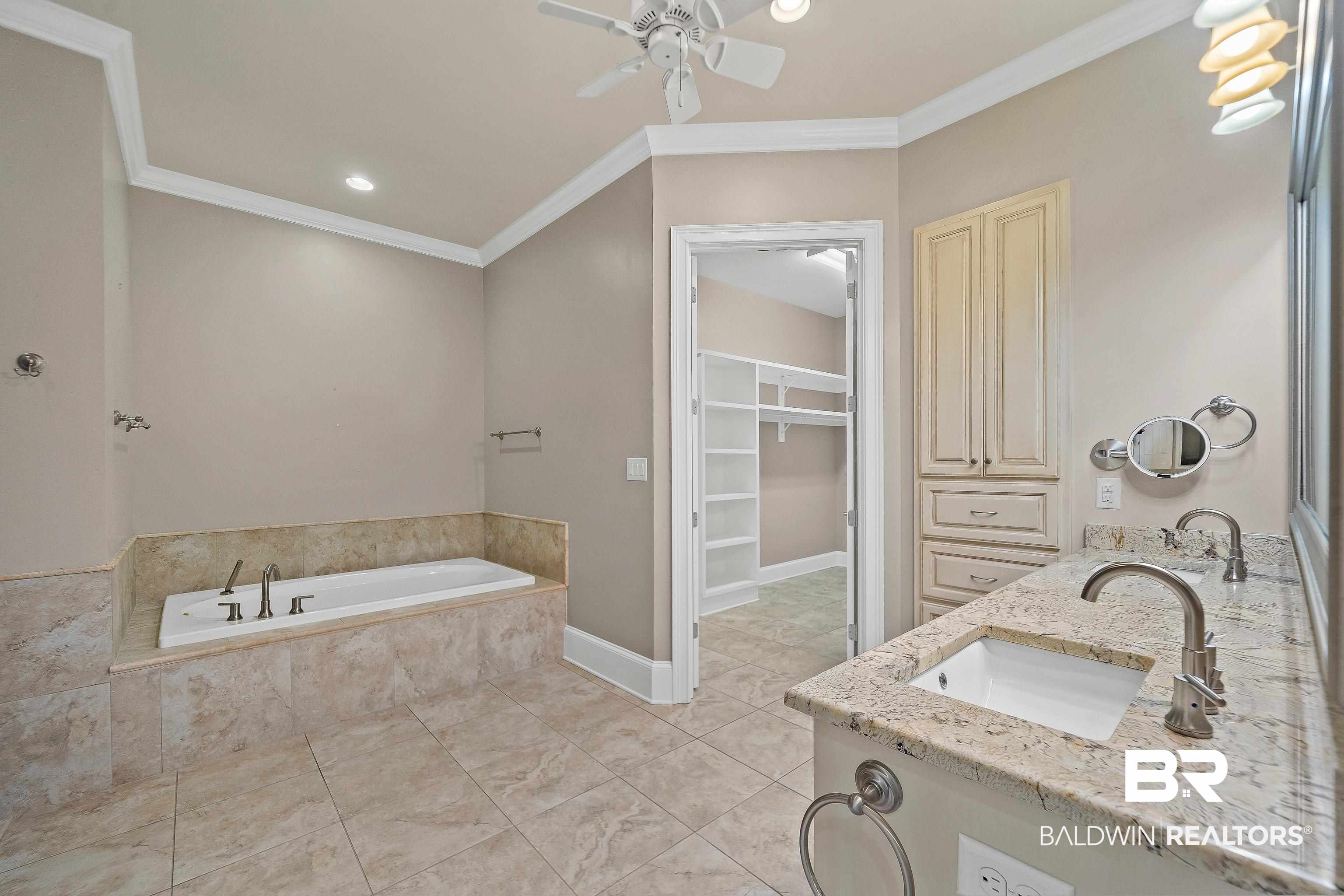 17663 Burwick Loop Fairhope, AL 36532 - Photo 27 of 41 Bathroom with ceiling fan, tiled bath, vanity, and ornamental molding