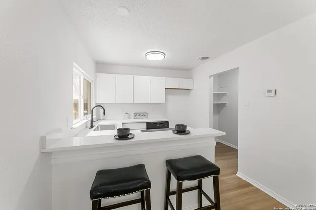 a kitchen with stainless steel appliances a sink and a stove