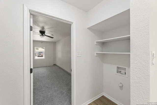 a view of an empty room with closet