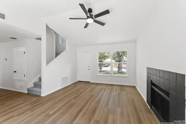 wooden floor in an empty room with a window