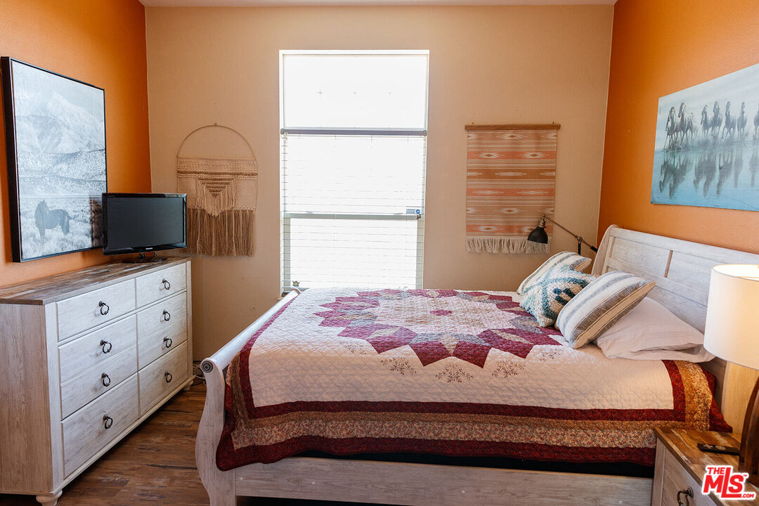 55626 Pipes Canyon Road Yucca Valley, CA 92284 - Photo 12 of 61 a bedroom with a bed and a flat screen tv