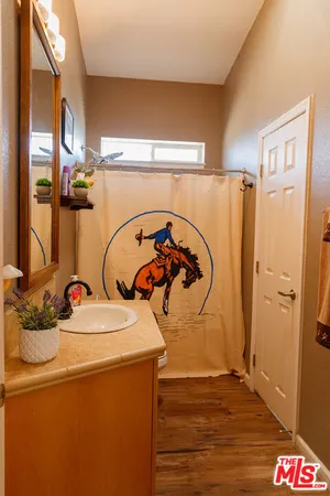 a room with water heater and wooden cabinets