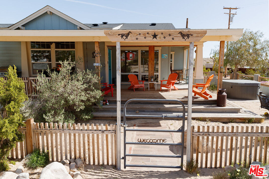 55626 Pipes Canyon Road Yucca Valley, CA 92284 - Photo 18 of 61 a view of a house with entrance door and balcony