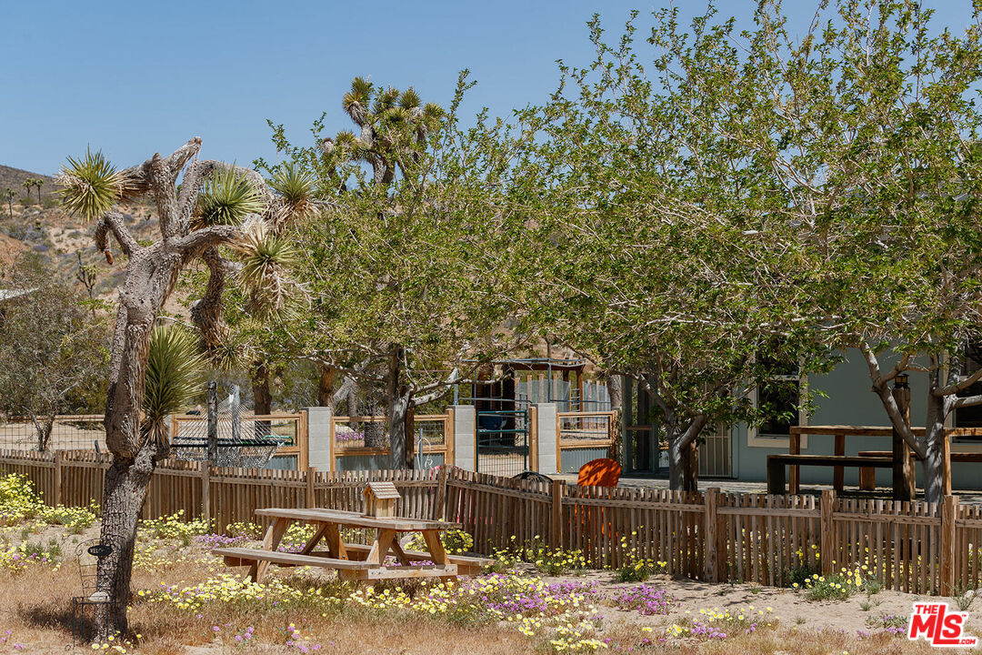 55626 Pipes Canyon Road Yucca Valley, CA 92284 - Photo 21 of 61 a front view of a house with a tree