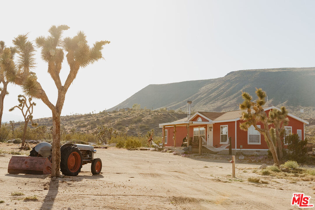 55626 Pipes Canyon Road Yucca Valley, CA 92284 - Photo 37 of 61 a view of a house with a yard