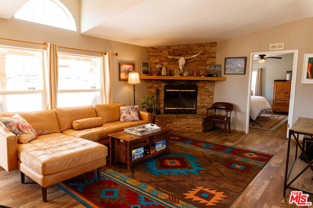 55626 Pipes Canyon Road Yucca Valley, CA 92284 - Photo 39 of 61 a living room with furniture and a fireplace
