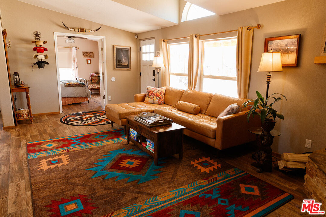 55626 Pipes Canyon Road Yucca Valley, CA 92284 - Photo 40 of 61 a living room with furniture and wooden floor