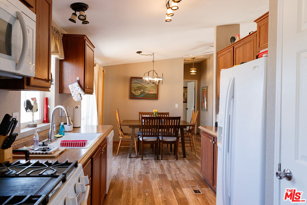 55626 Pipes Canyon Road Yucca Valley, CA 92284 - Photo 42 of 61 a view of a dining room with furniture and wooden floor
