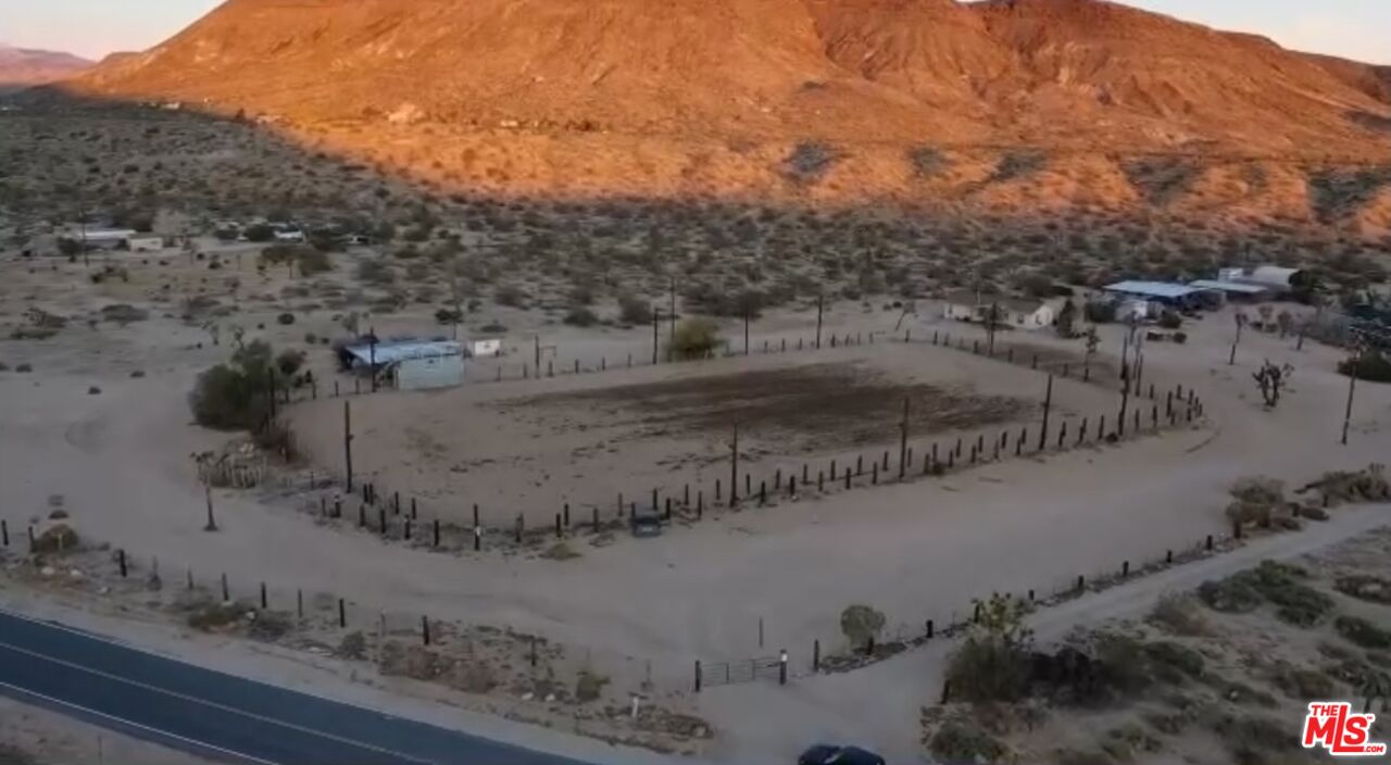 55626 Pipes Canyon Road Yucca Valley, CA 92284 - Photo 51 of 61 a view of a dry yard with wooden fence