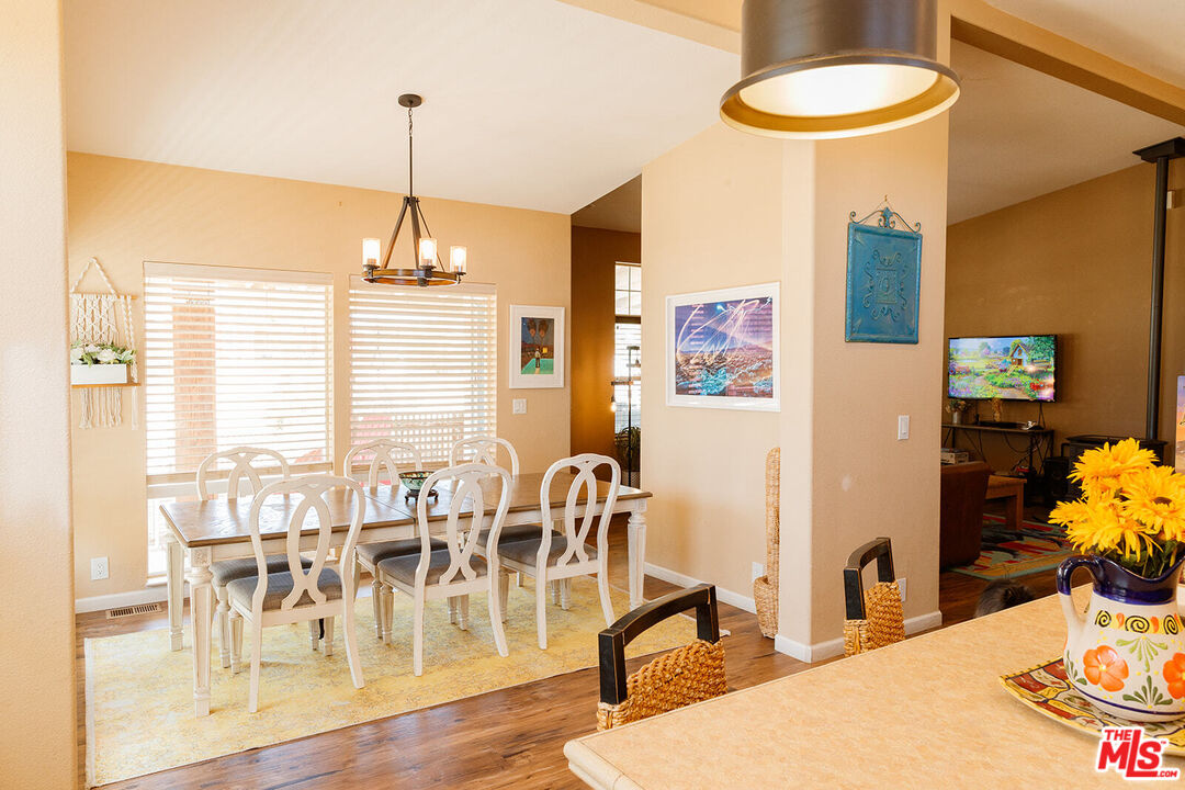 55626 Pipes Canyon Road Yucca Valley, CA 92284 - Photo 7 of 61 a dining room with furniture and wooden floor