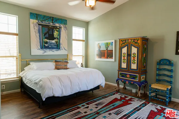 a bed sitting in a bedroom next to a window