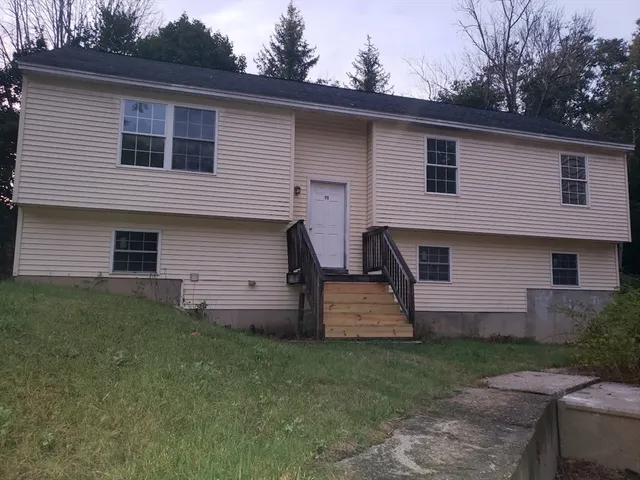a front view of house with yard and green space