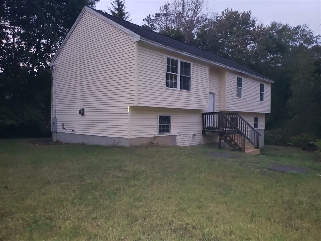21 Spencer Road Oakham, MA 01068 - Photo 22 of 25 a view of a house with a backyard